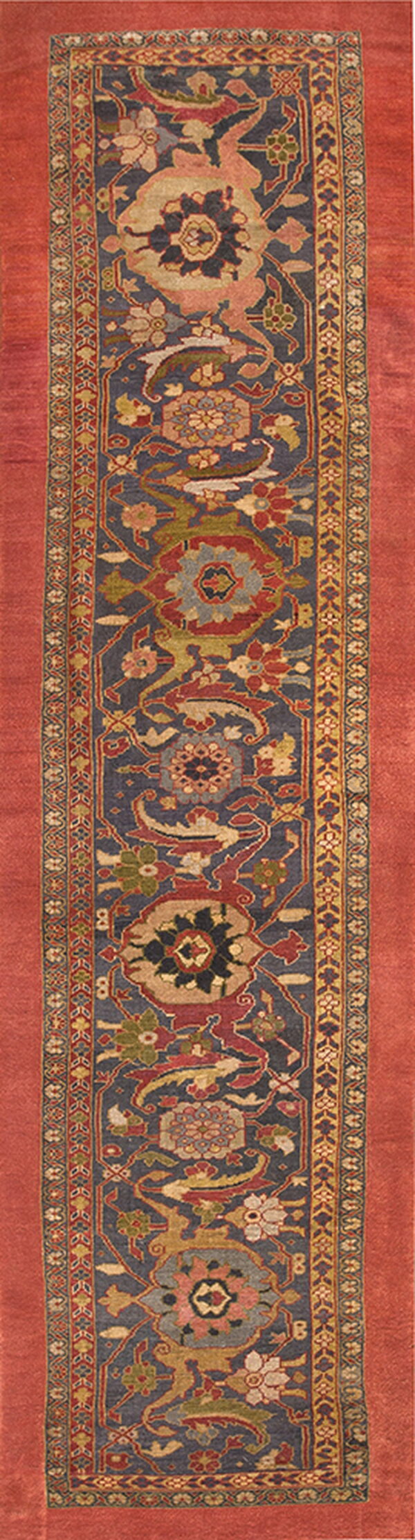 A long runner rug featuring a detailed floral pattern on a slate blue field with wide terracotta borders.