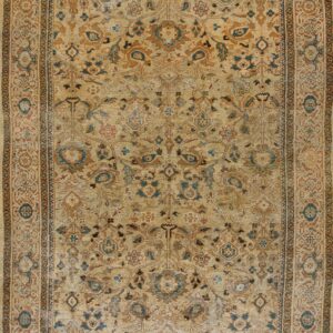 Low-pile tan rug featuring an elaborate distressed pattern in rust, brown, and muted teal colors.