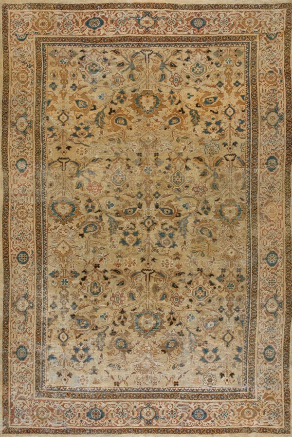 Low-pile tan rug featuring an elaborate distressed pattern in rust, brown, and muted teal colors.