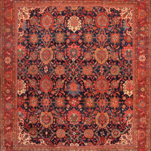 Intricate traditional rug with red and cream floral designs on a deep navy blue background and wide red border.