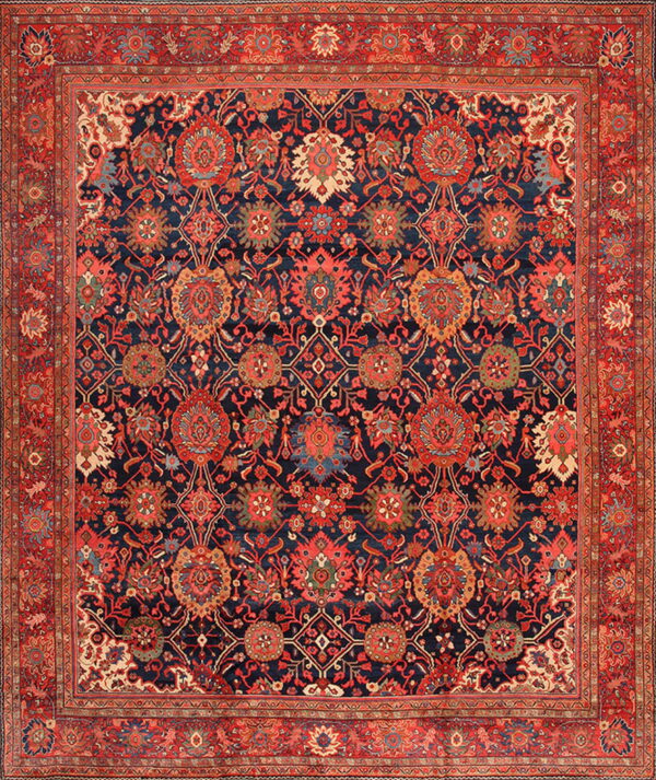 Intricate traditional rug with red and cream floral designs on a deep navy blue background and wide red border.