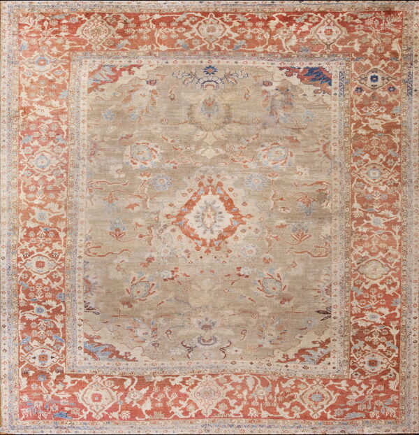 Muted traditional rug with an intricate beige field and wide red-orange ornamental borders.