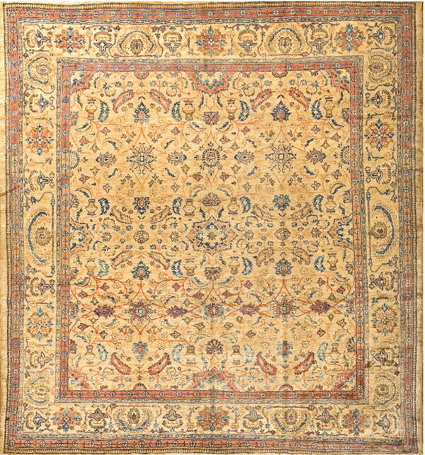 Traditional square rug with a golden beige field and ornate botanical patterns in muted blue and rust.