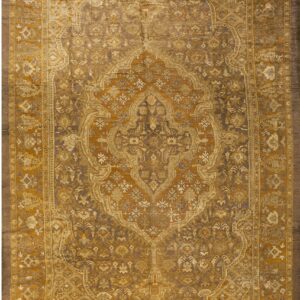 Elaborate traditional area rug with a large gold and brown ornamental medallion and borders.