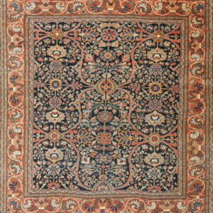 Traditional rug with a navy blue field filled with complex floral medallions and rust orange borders.