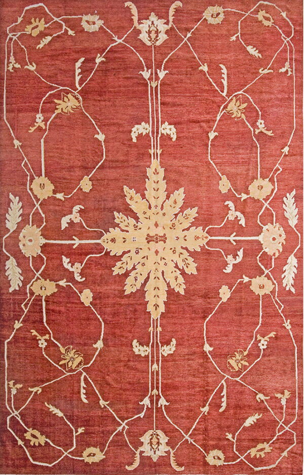 Terracotta rug with an elaborate beige central motif framed by delicate scrolling floral designs.