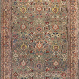 Intricate low-pile rug with a muted sage green field, rust border, and detailed floral motifs in varied colors.