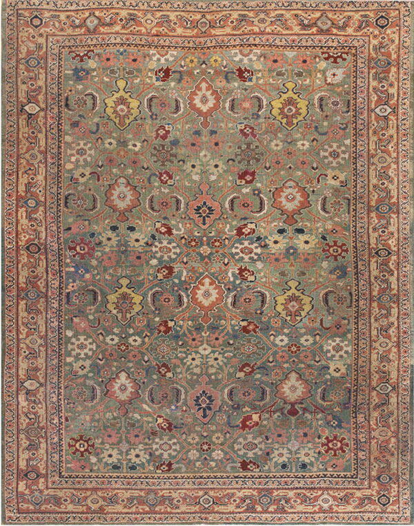 Intricate low-pile rug with a muted sage green field, rust border, and detailed floral motifs in varied colors.