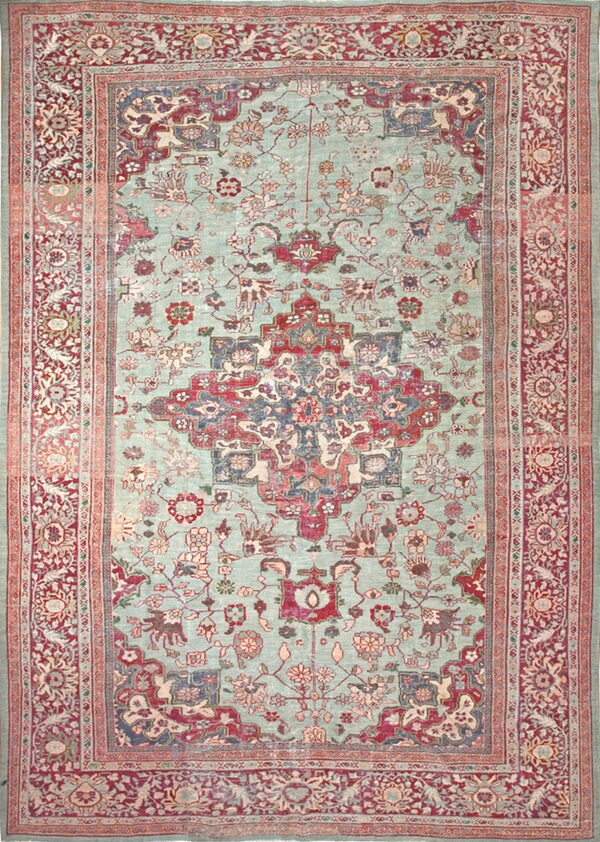 Ornate area rug with a mint green field, featuring a large red central medallion and detailed borders.