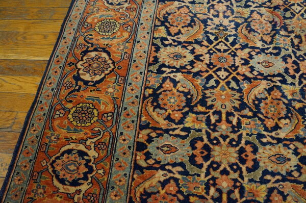 A navy and orange traditional rug with intricate floral motifs is partially visible on hardwood.