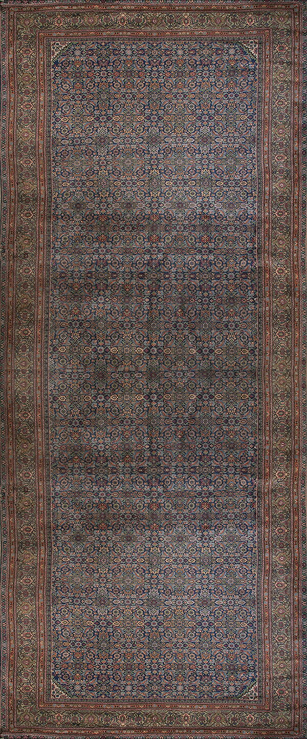 Long runner rug with a dense traditional pattern in deep blue, rust, and olive tones.
