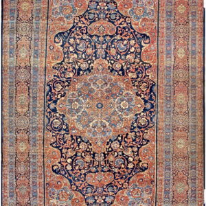 Navy blue area rug with an intricate medallion and floral pattern bordered in rust and light blue.