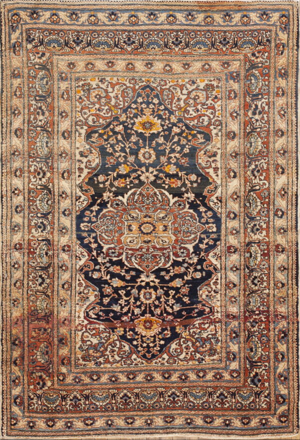 A detailed traditional rug featuring a navy blue medallion field and wide borders in beige and rust.
