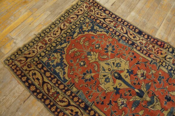 Ornate red, dark blue, and beige low-pile rug lying diagonally on light distressed wood planks.