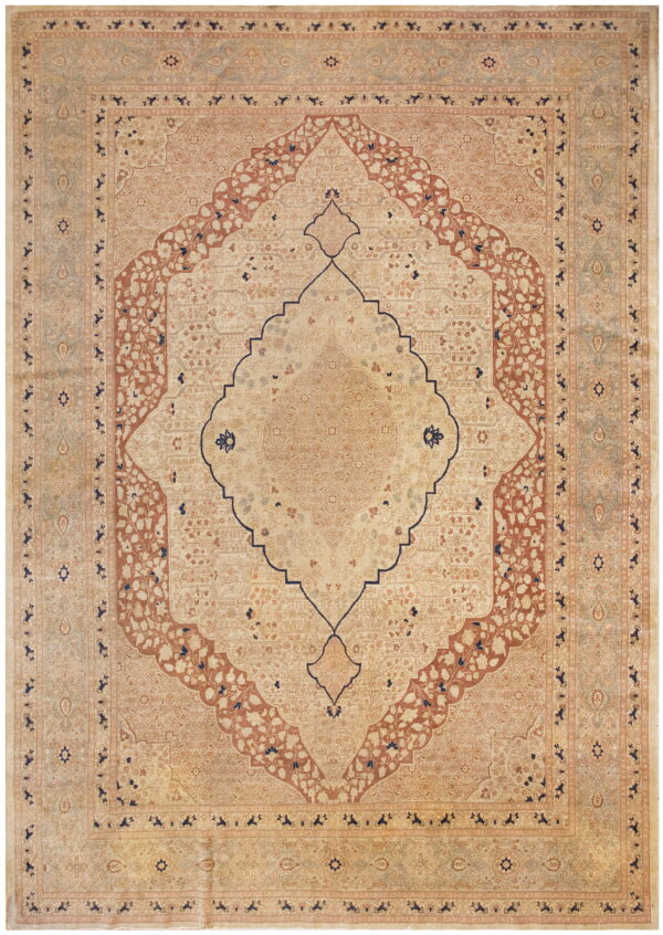 Ornate area rug featuring a central medallion and detailed floral motifs in cream, terracotta, and navy.