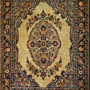Traditional rug with a gold field, a pink and blue medallion, and dark navy floral borders.