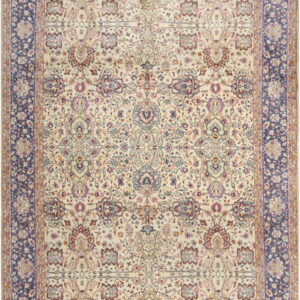 Cream rug featuring a complex floral pattern in maroon and purple with a wide dark blue border.