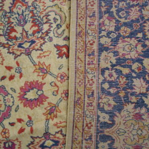 Two adjacent rug sections display contrasting cream and navy blue fields with red and pink floral patterns.