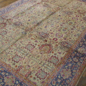 Ornate low-pile rug featuring a cream field with colorful floral motifs and wide navy blue borders.