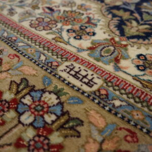 Intricate floral design on ivory rug.
