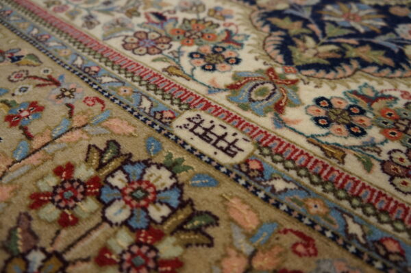 Intricate floral design on ivory rug.
