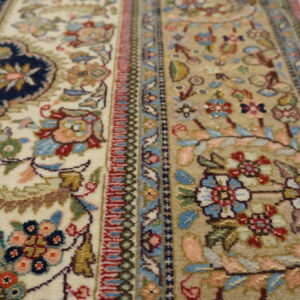 Intricate floral patterns on ivory rug