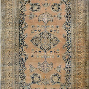 Traditional rectangular rug featuring a peach field, dark blue medallion, and ornate floral borders.