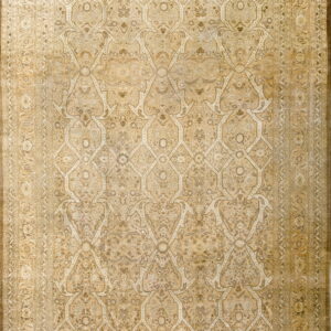 Beige and gold rug featuring a dense floral pattern within a traditional repeating ogival lattice.