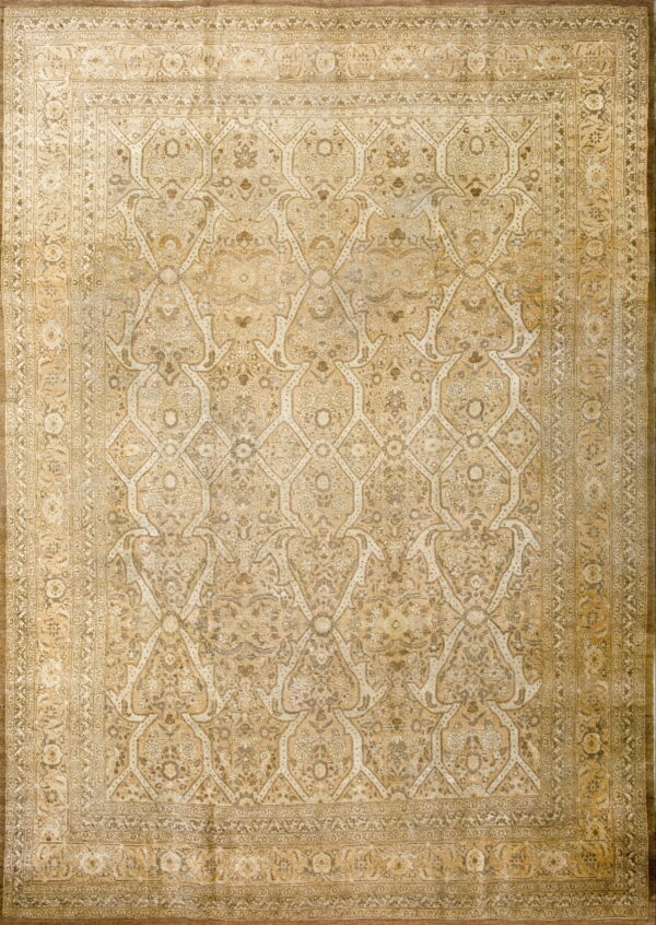 Beige and gold rug featuring a dense floral pattern within a traditional repeating ogival lattice.