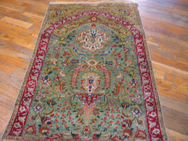 Rare green color fine luxurious silk pile antique persian tabriz islamic prayer design rug 6 Green and red pictorial rug featuring a mihrab design and dense floral motifs on hardwood planks.
