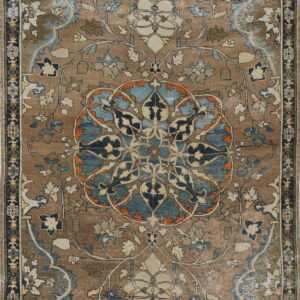 Brown and blue oriental rug with an intricate floral medallion pattern and faded coloring.