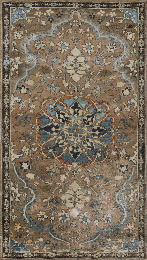 Brown and blue oriental rug with an intricate floral medallion pattern and faded coloring.