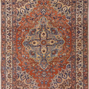 Traditional rust red low-pile rug with a blue medallion and intricate floral borders on a cream ground.