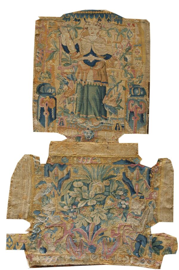 Intricately woven tapestry fragment featuring a figure and dense foliage in gold, teal, green, and pink.