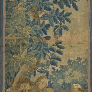Pictorial tapestry woven in blue, teal, and tan depicting four figures beneath heavy, leafy woodland foliage.