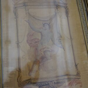 Muted gold tapestry framed in ornate molding depicts a classical figure, positioned next to distressed gray wood paneling.
