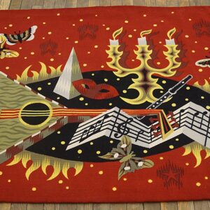 Red rug displaying a colorful abstract design of music notes, candelabra, and butterflies on wooden floorboards.