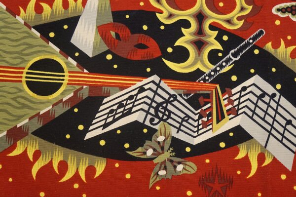 Abstract rug pattern with geometric red, black, yellow shapes, musical notes, and stylized instruments.