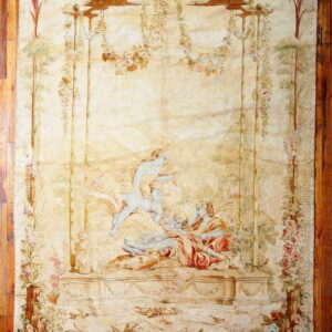 Cream-colored pictorial textile depicting three figures in a garden setting surrounded by vines and birds on wood flooring.