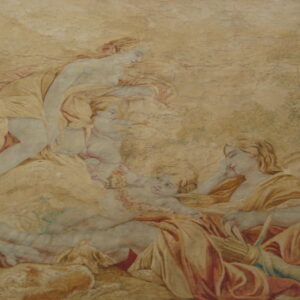 Pictorial rug displaying a reclining classical scene using muted tan, gold, blue, and red tones.