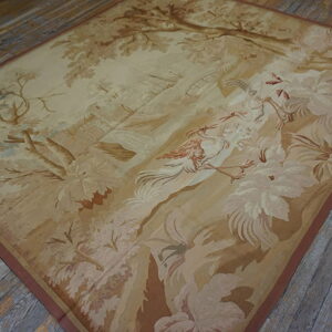 Beige and brown scenic rug with birds and foliage lies on weathered wooden plank flooring.