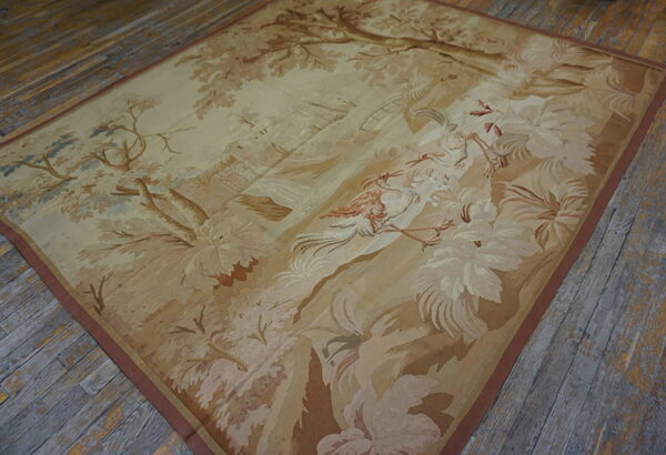 Beige and brown scenic rug with birds and foliage lies on weathered wooden plank flooring.