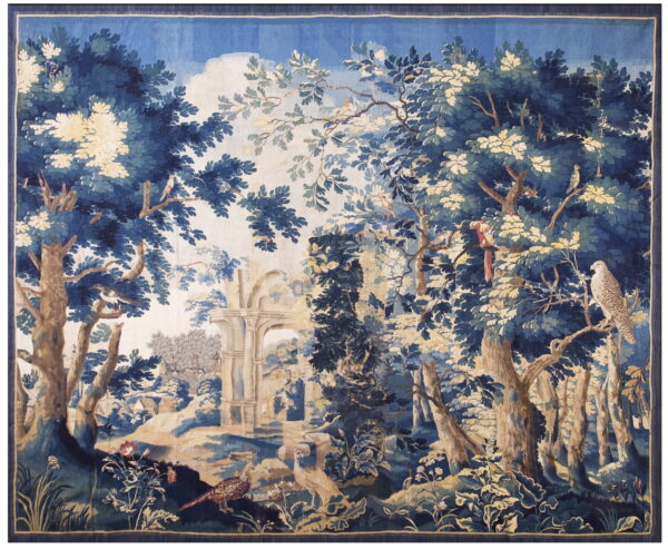 Navy blue and cream flat-woven tapestry depicting a dense woodland scene with birds and stone ruins.