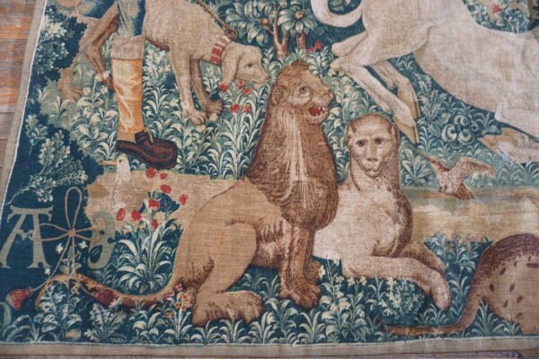 Detailed tapestry featuring animals and foliage.