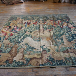 Colorful tapestry depicting forest scene.