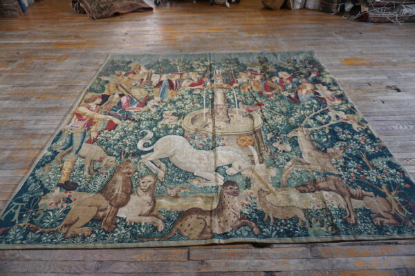 Colorful tapestry depicting forest scene.