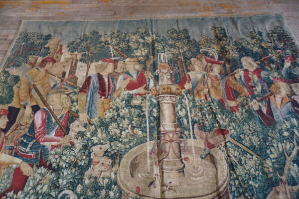 Colorful tapestry depicting historical scene.