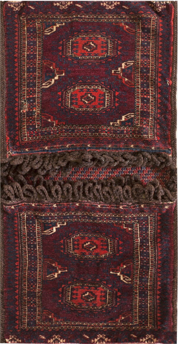 Double-sided textile featuring deep red geometric pile panels separated by thick brown looped fringe.
