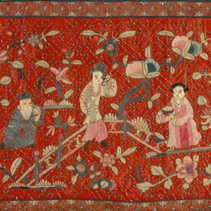 Vibrant red embroidered textile featuring three figures, detailed pink and blue flowers, and a complex scrolled border.