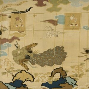 Pale yellow rug with an ornate design of birds, clouds, and flowers using green, blue, and earthy brown colors.